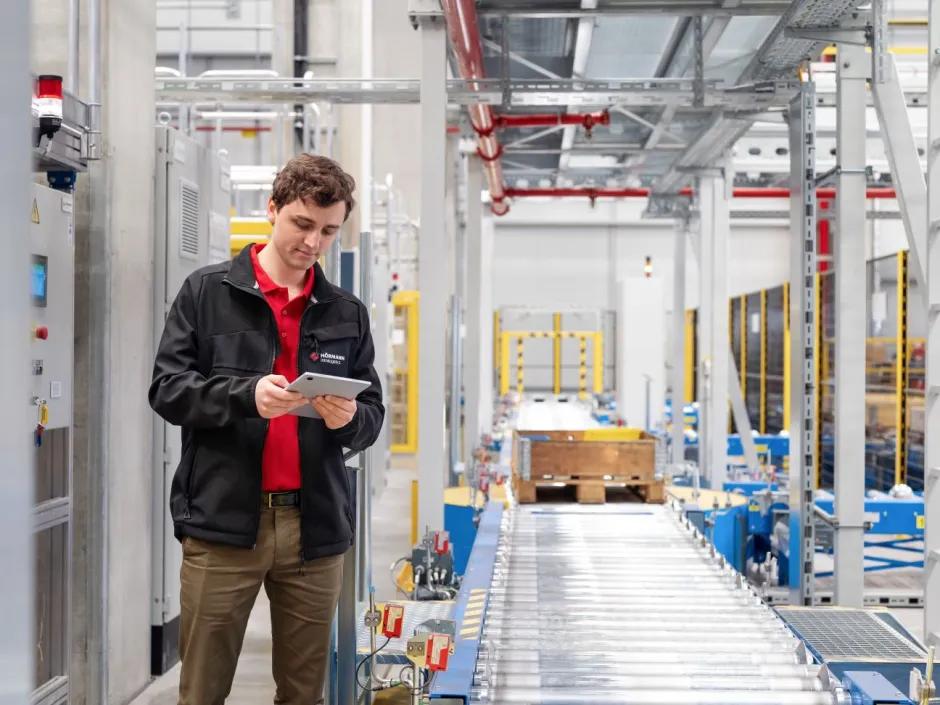 Project manager at work in high-bay warehouse